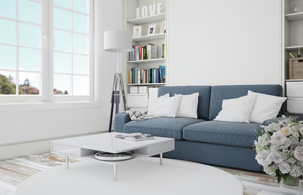 Minimalist living room with a blue sofa, white coffee table, large window, and bookshelf. Minimalist living room with a blue sofa, white coffee table, large window, and bookshelf.