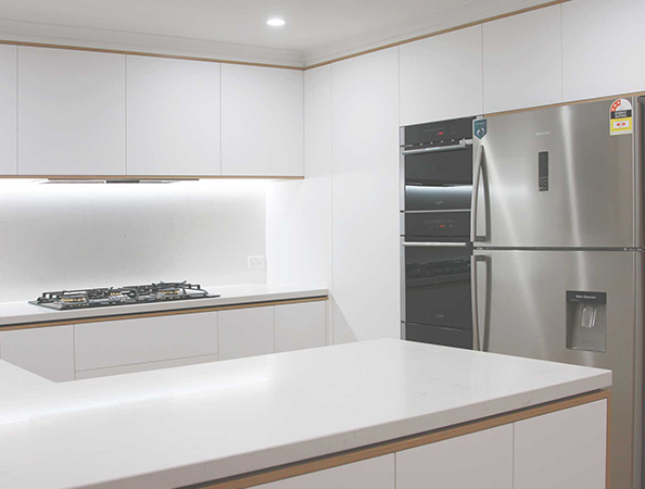 Modern kitchen with white cabinets, stainless steel appliances, and a sleek countertop with built-in stove. Modern kitchen with white cabinets, stainless steel appliances, and a sleek countertop with built-in stove.