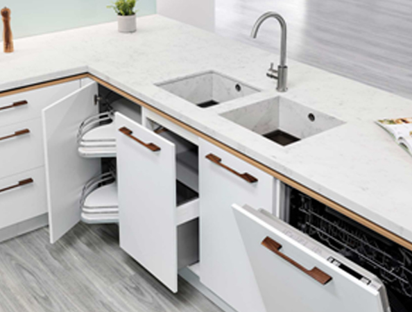 Modern kitchen with white cabinets, open drawers, a double sink, and a visible dishwasher. Plant on countertop. Modern kitchen with white cabinets, open drawers, a double sink, and a visible dishwasher. Plant on countertop.